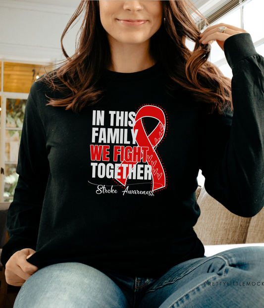 a woman wearing a black shirt with a red ribbon on it