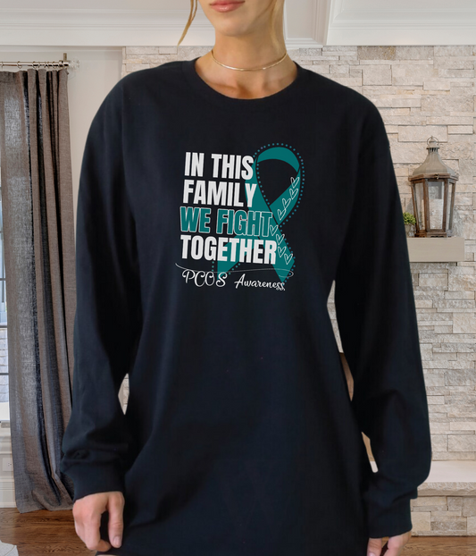 a woman wearing a t - shirt that says in this family we fight together
