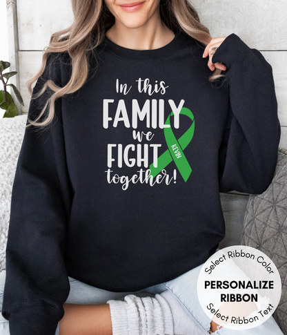 a woman wearing a sweatshirt that says in this family we fight together