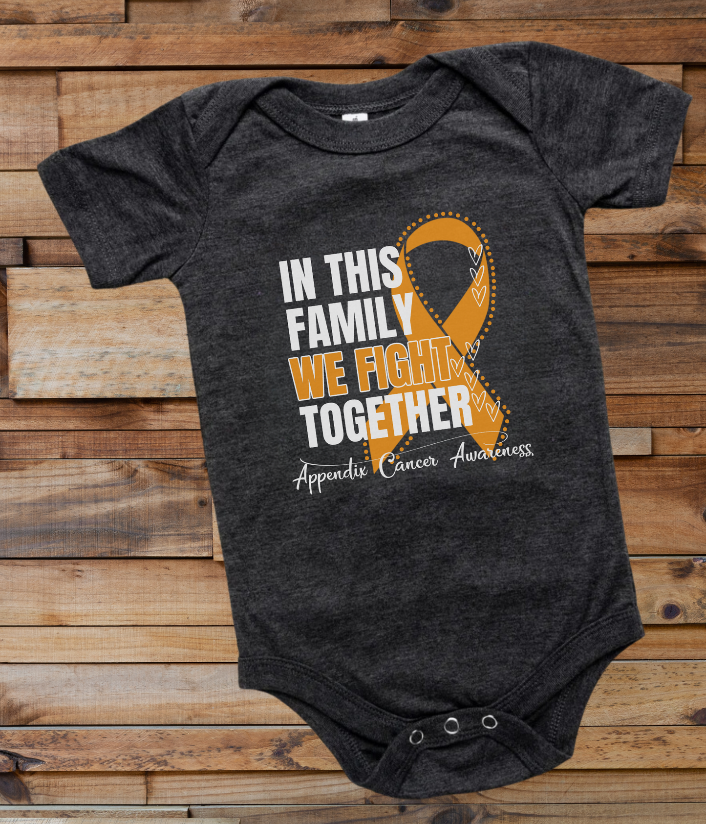 a black onesuit with an orange ribbon in this family we fight together