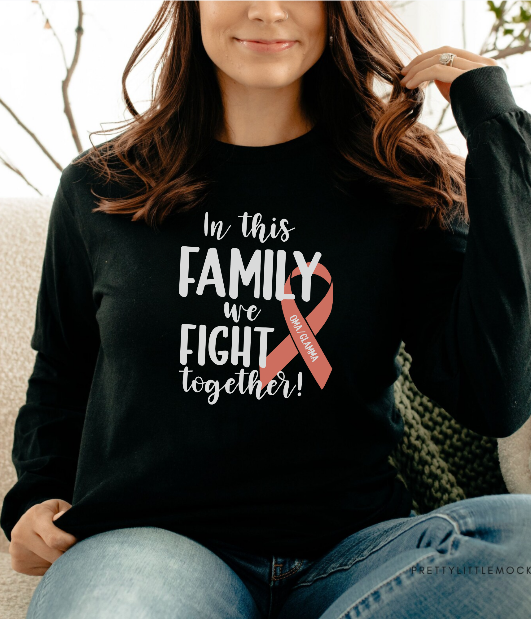 a woman sitting on a couch wearing a black shirt