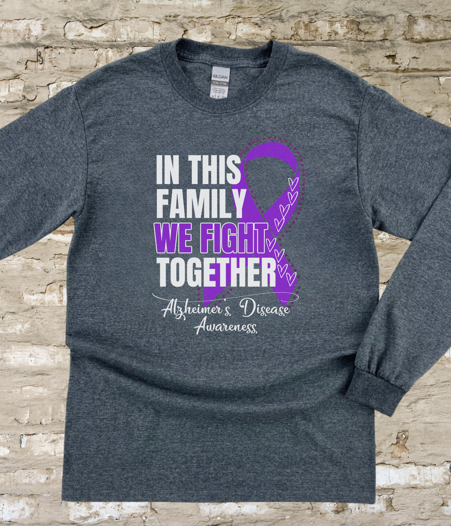 a t - shirt with a purple ribbon on it that says in this family we