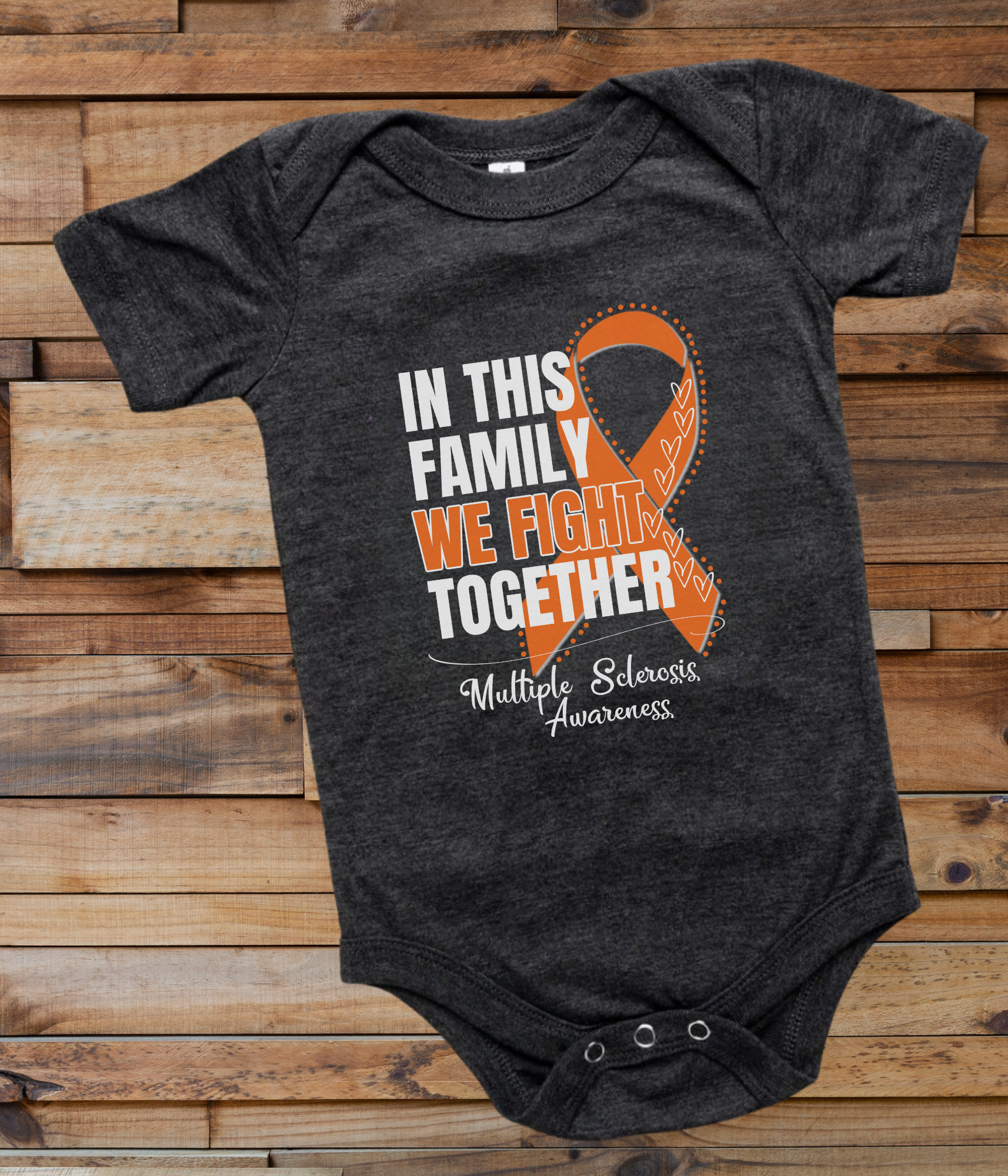 a black onesuit with an orange ribbon in this family we fight together