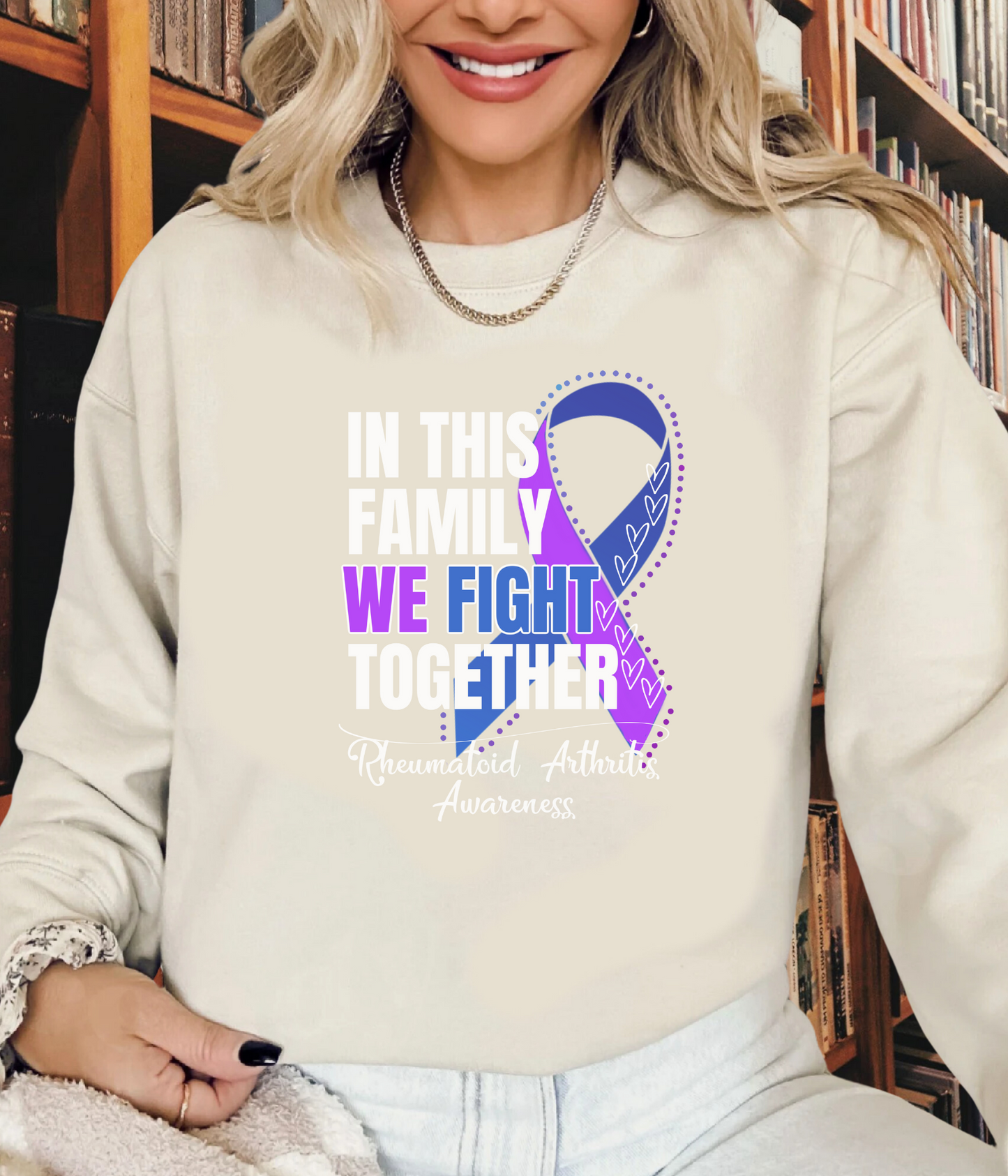 a woman wearing a sweatshirt with a purple ribbon on it