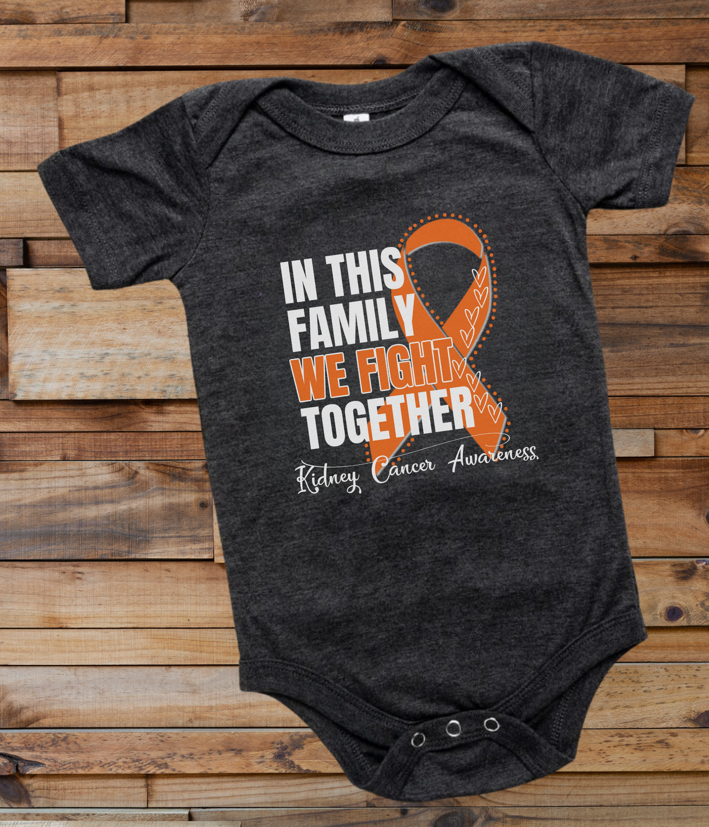 a black onesuit with an orange ribbon in this family we fight together